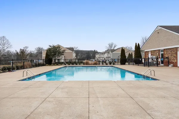 a view of swimming pool with outdoor seating and in the background