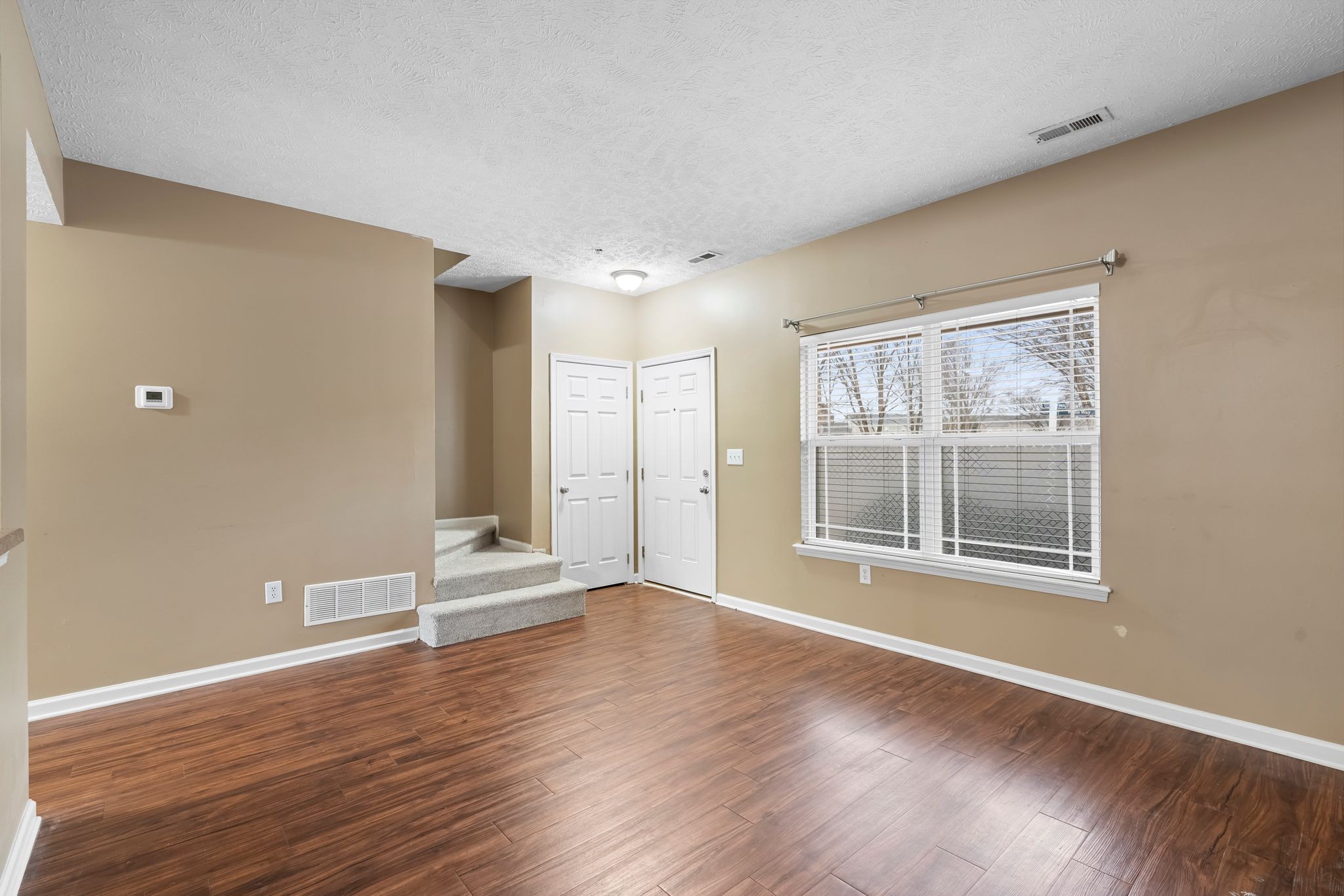 1000 Wells Way Spring Hill, TN 37174 - Photo 6 of 36 a view of an empty room with wooden floor and a window