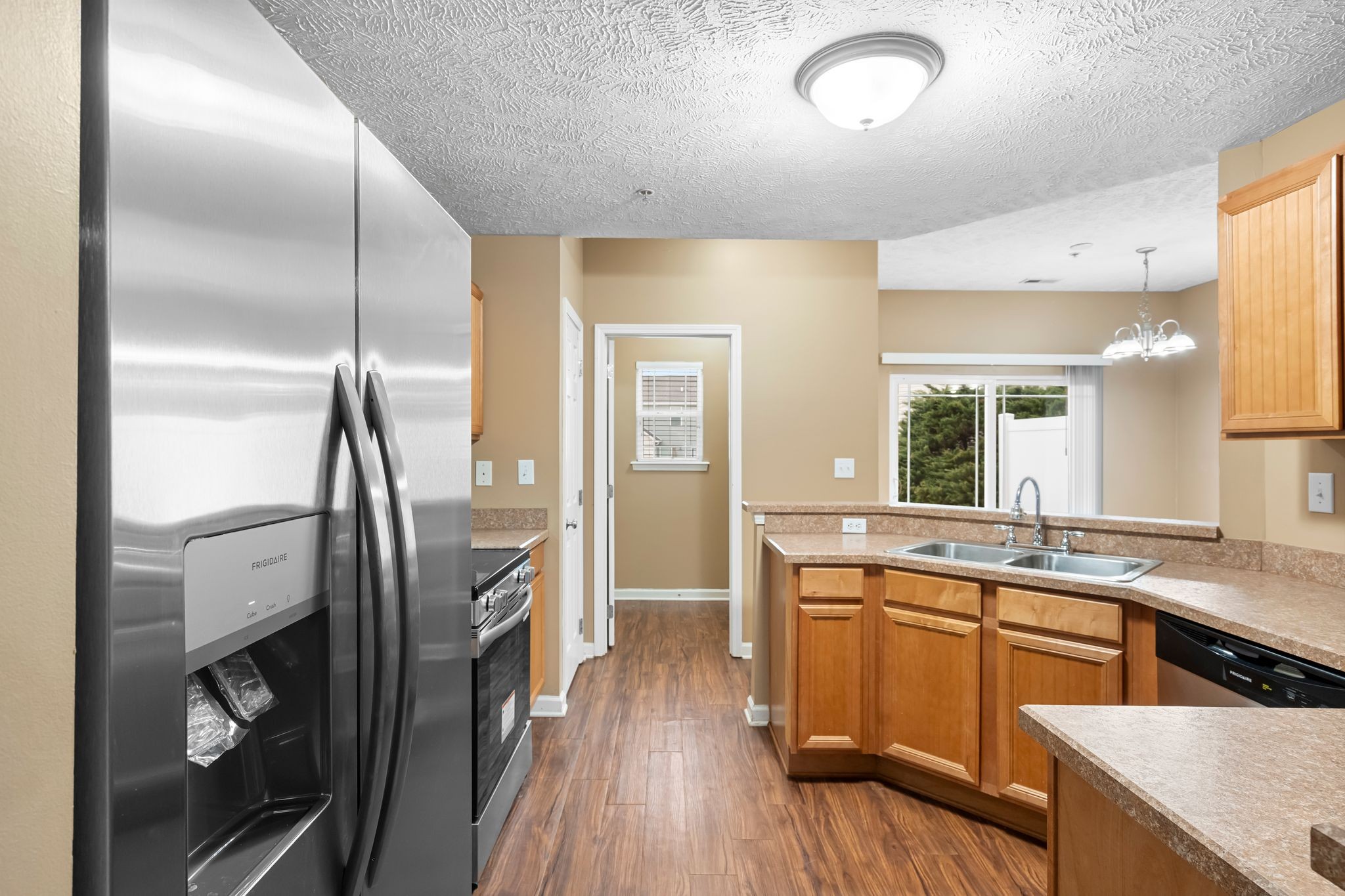 1000 Wells Way Spring Hill, TN 37174 - Photo 9 of 36 a kitchen with stainless steel appliances granite countertop a refrigerator a sink and white cabinets