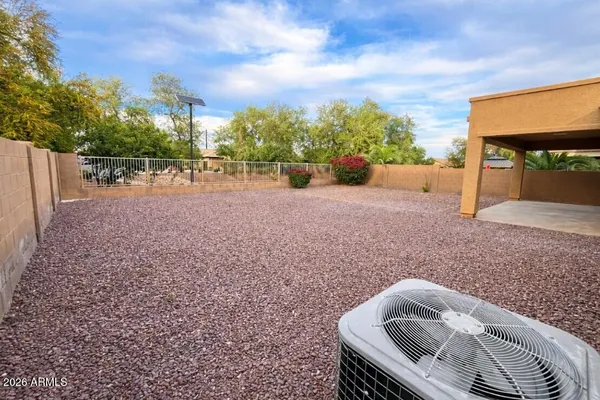 a view of backyard with swimming pool and outdoor seating