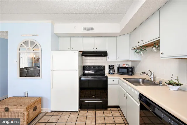 a kitchen with a white cabinets and white appliances