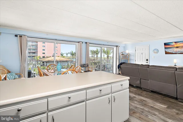 a kitchen with a sink a stove a refrigerator and white cabinets