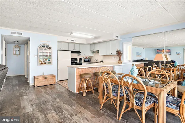 a kitchen with appliances a sink a counter top space and cabinets