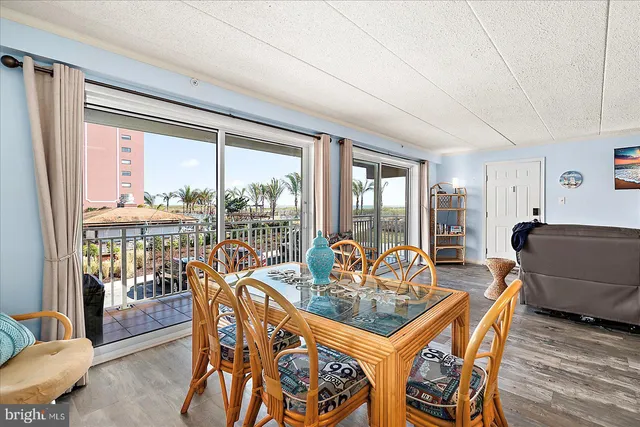 a view of a dining room with furniture and a kitchen
