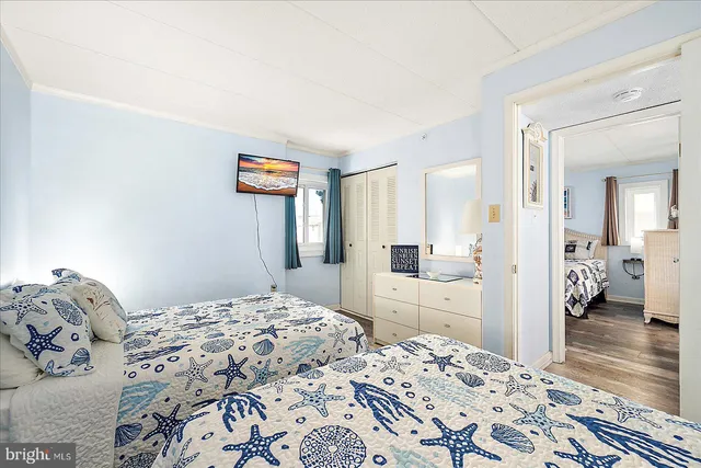 a bedroom with two bed and a lamp