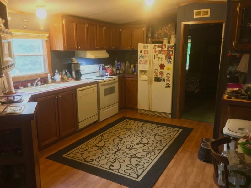 213 Midkiff Road Southeast Floyd, VA 24091 - Photo 14 of 20 a kitchen with stainless steel appliances granite countertop a refrigerator and a sink
