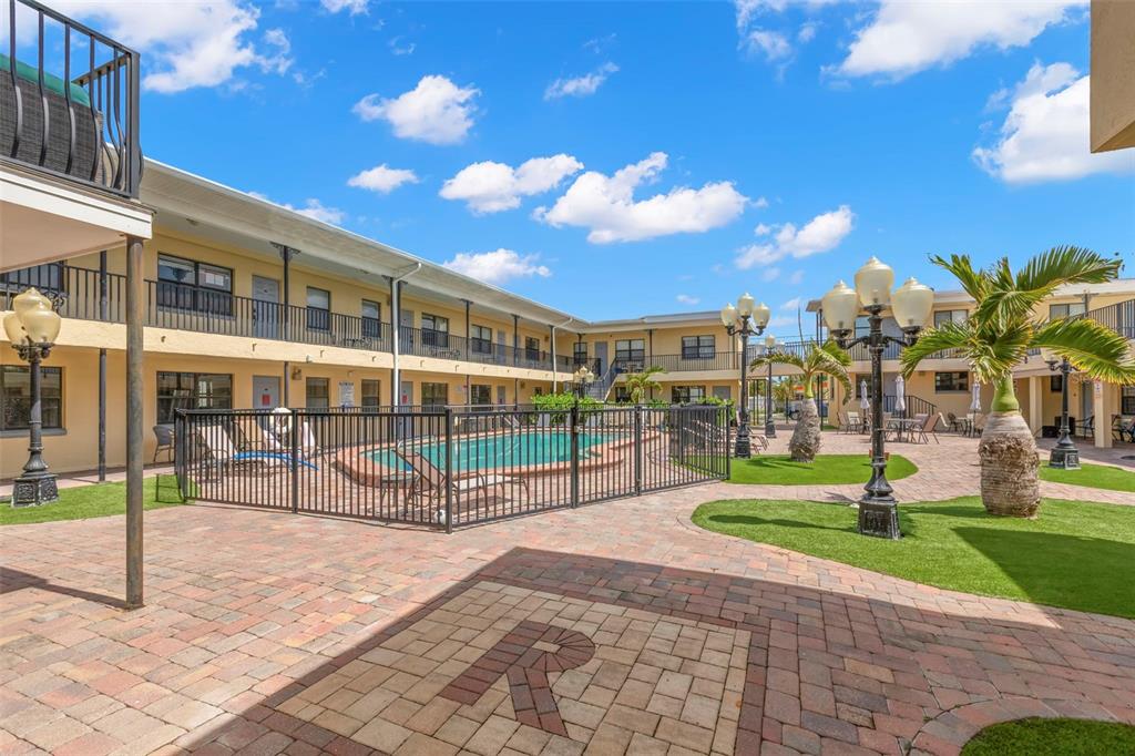 16333 Gulf Boulevard, Unit 113 Redington Beach, FL 33708 - Photo 21 of 40 a view of a building with a yard