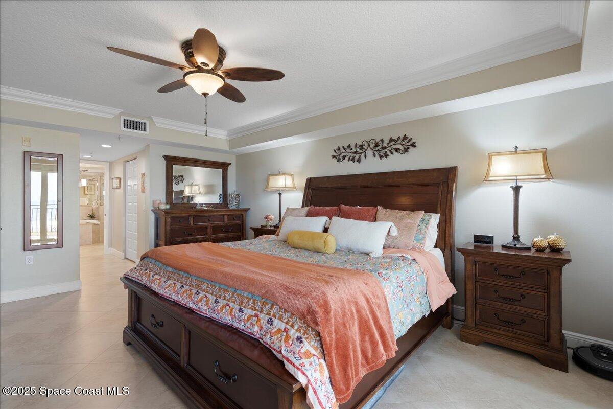 2375 South Atlantic Avenue, Unit 302 Cocoa Beach, FL 32931 - Photo 14 of 36 a bedroom with a bed chandelier and a window