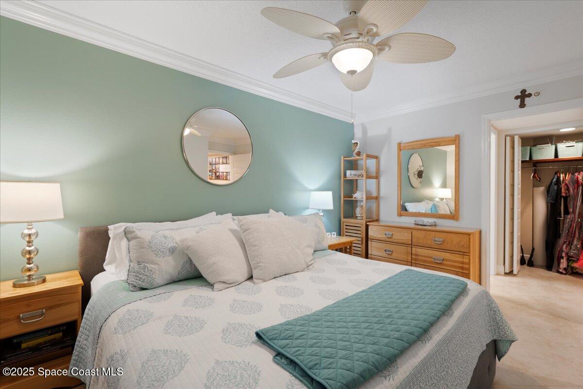 2375 South Atlantic Avenue, Unit 302 Cocoa Beach, FL 32931 - Photo 18 of 36 a bedroom with a large bed and a chandelier