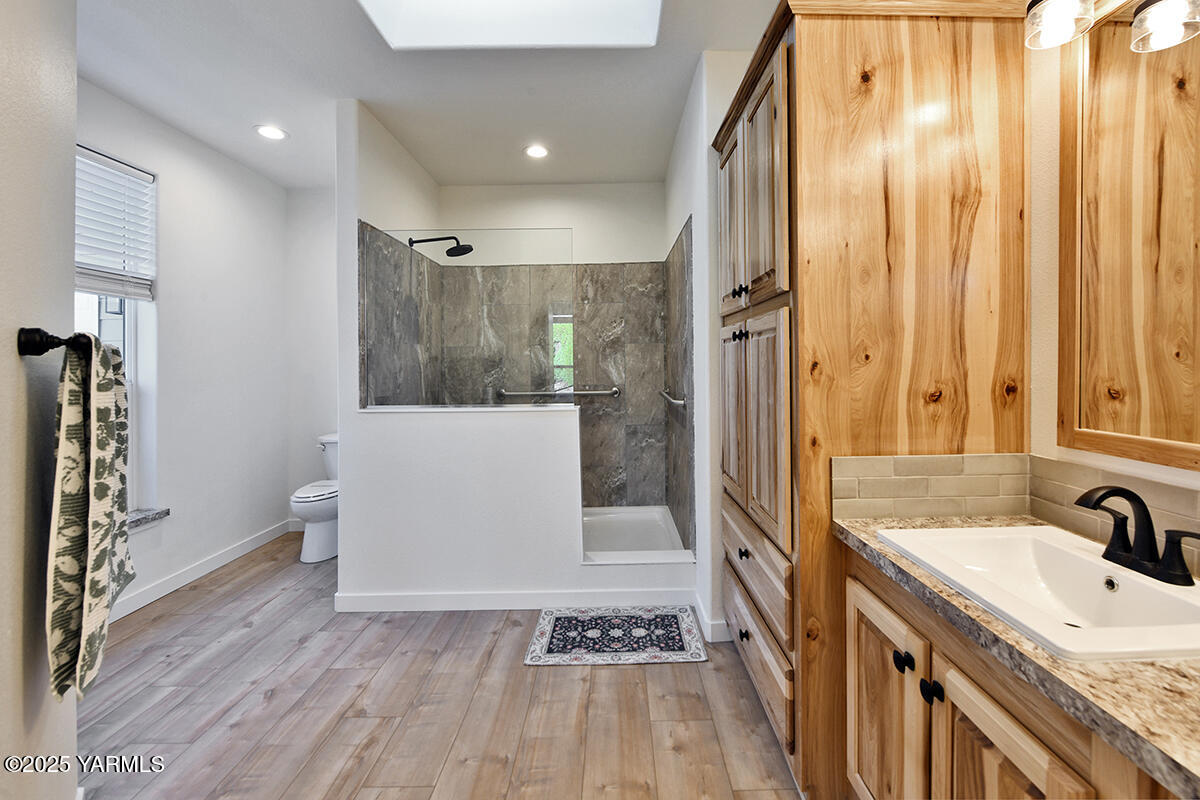 200 Bridle Way, Unit 129 Yakima, WA 98901 - Photo 18 of 20 a bathroom with a granite countertop sink toilet and shower