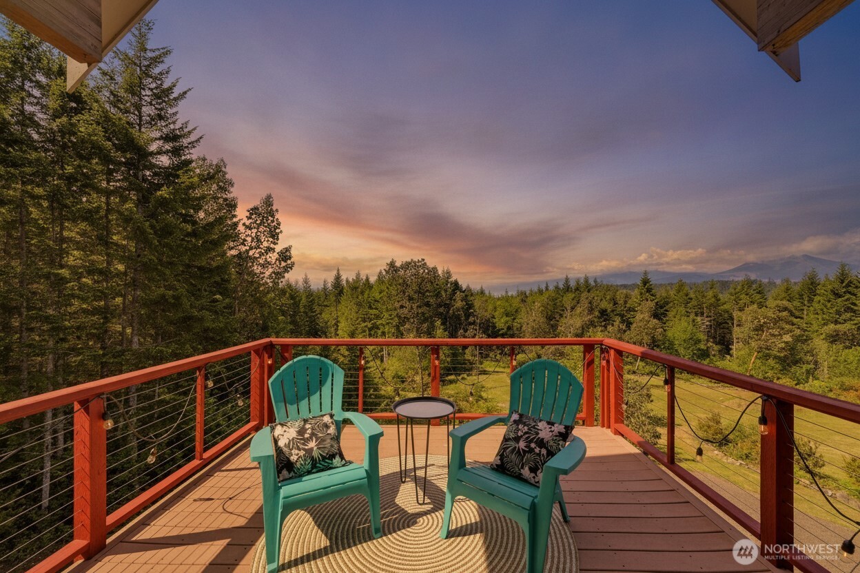 83 Octopus Court Quilcene, WA 98376 - Photo 2 of 40 a view of a balcony with wooden floor and outdoor seating