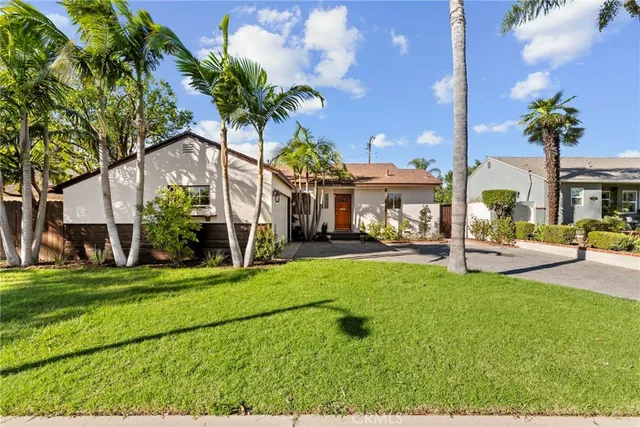 a house view with a sitting space and garden
