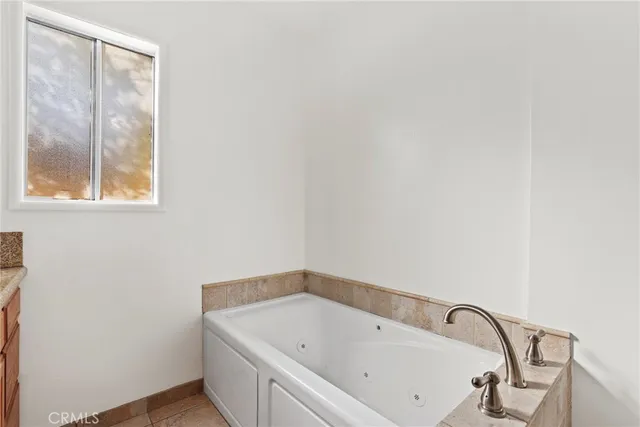 a bathroom with a bathtub and window