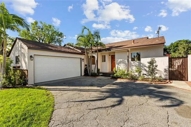 a front view of house along with road and seating space