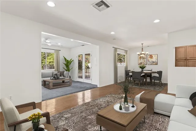 a living room with furniture and wooden floor