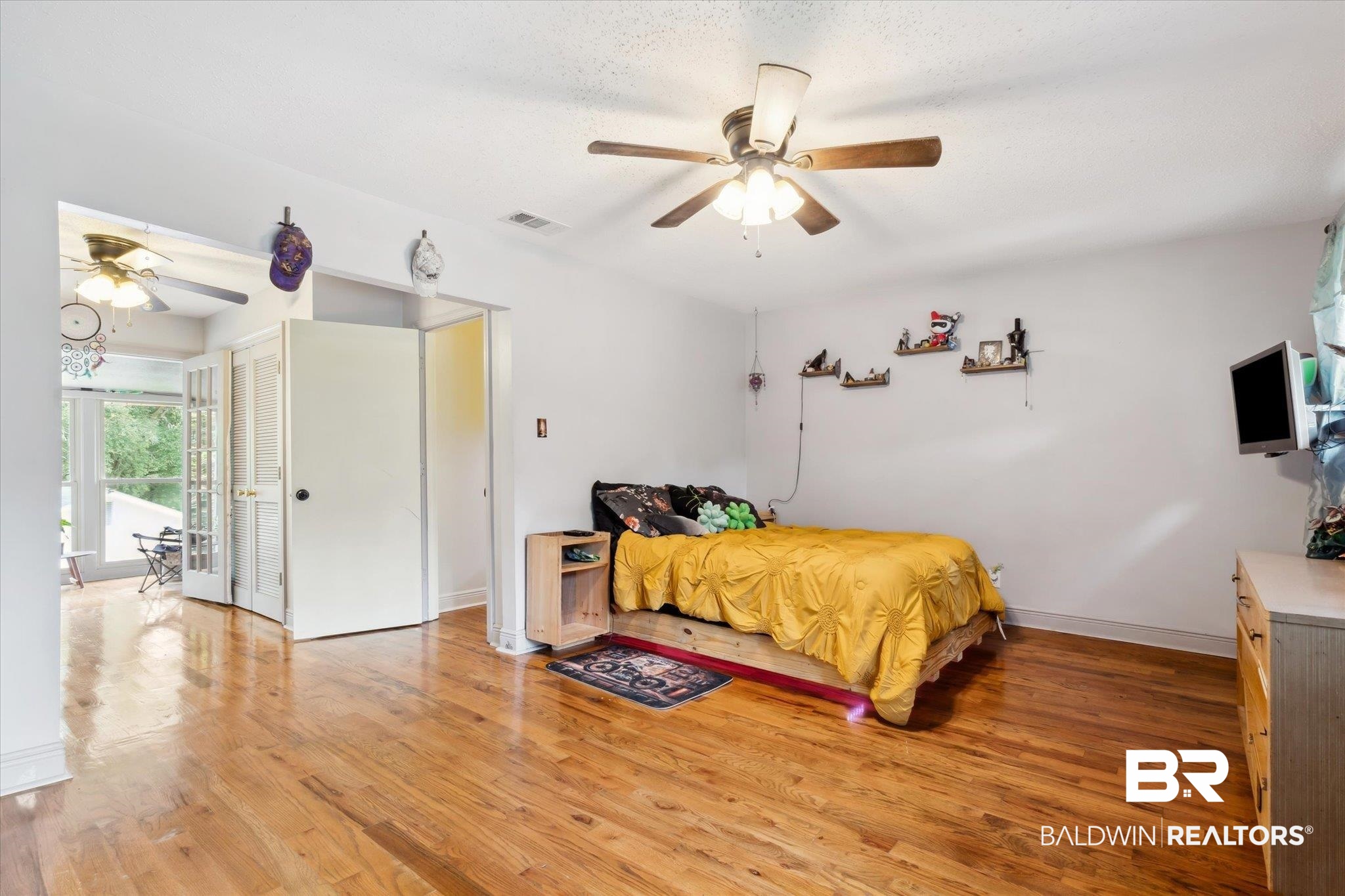 4851 Lesure Road Theodore, AL 36582 - Photo 10 of 21 Bedroom with light hardwood / wood-style flooring and ceiling fan