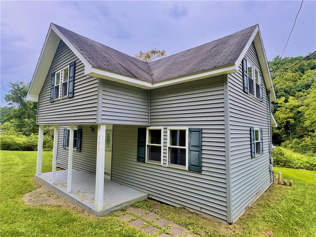 A classic covered porch highlights the exterior of this multi-level vinyl-sided home.