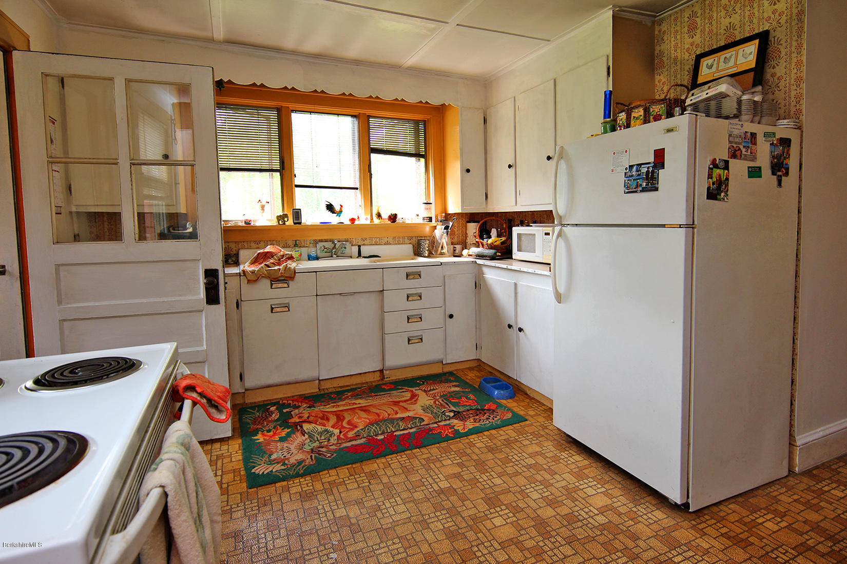 1455 State Road Richmond, MA 01254 - Photo 12 of 15 a kitchen with white cabinets and white appliances
