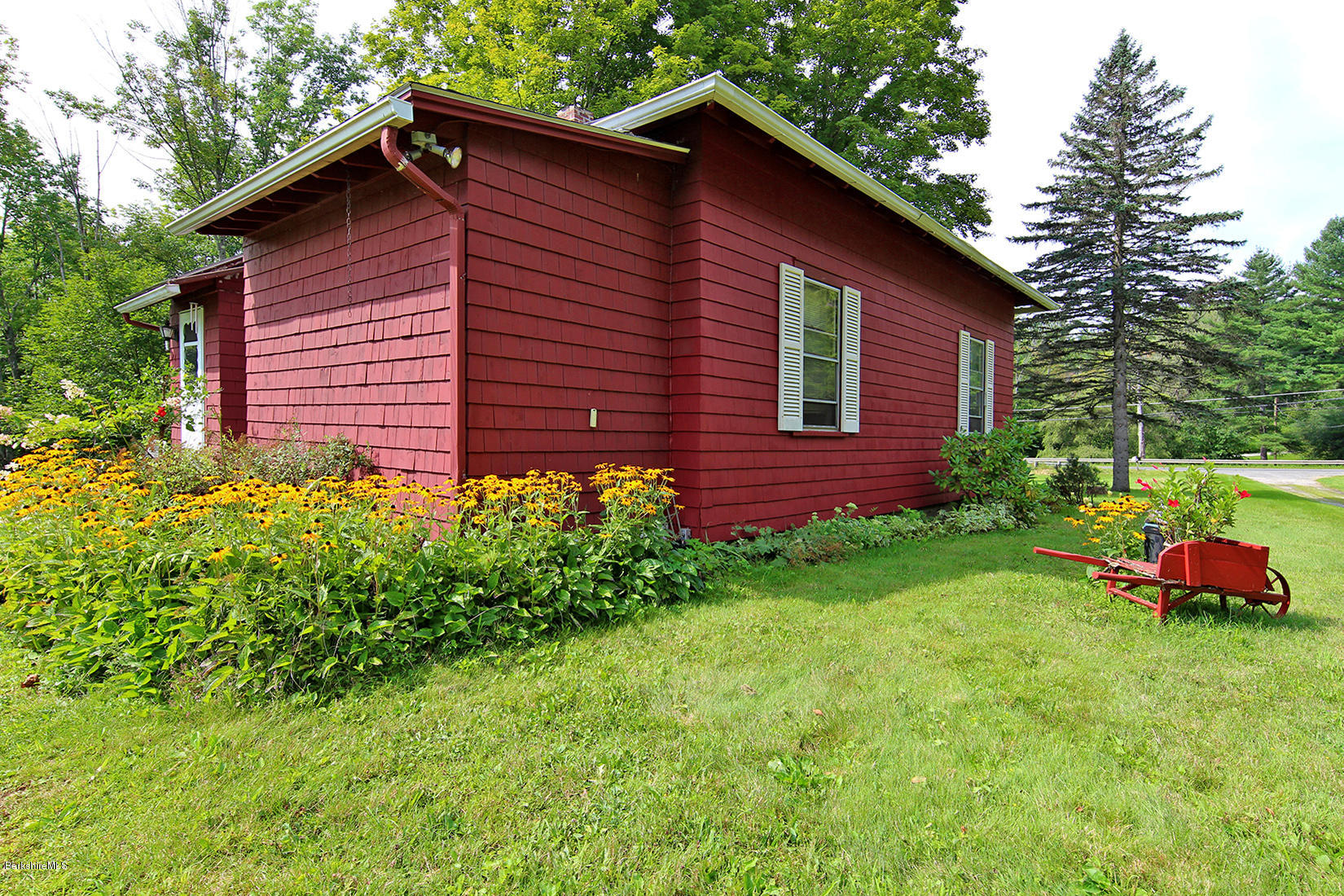 1455 State Road Richmond, MA 01254 - Photo 10 of 15 a red brick house with flower garden in front of it