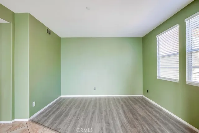 a view of an empty room with a window and a bedroom