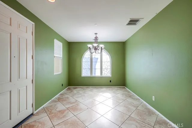 a kitchen with granite countertop a stove top oven and cabinets