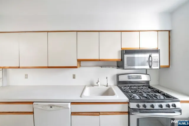 a big room with wooden floor and a bathroom