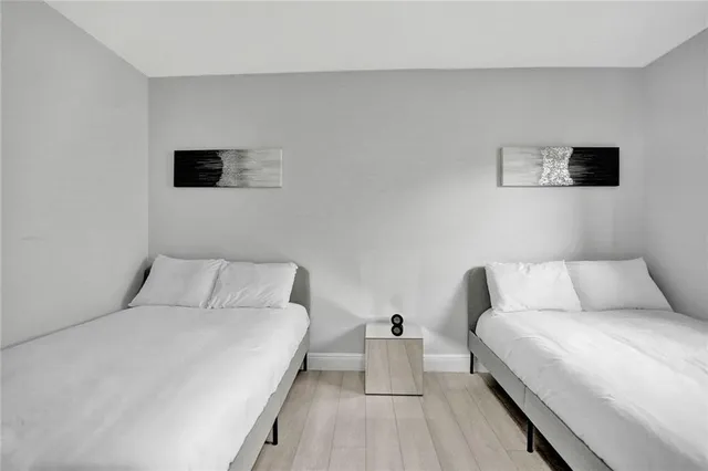 a bed room with a bed and a night stand