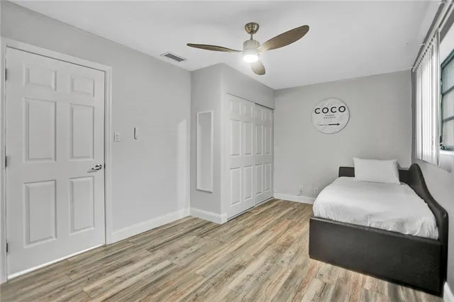 a bedroom with a bed and a ceiling fan