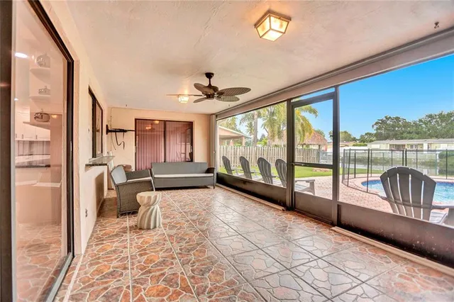 a living room with furniture and a floor to ceiling window
