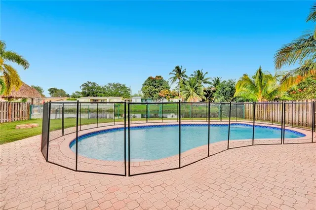 a view of a backyard with a swimming pool