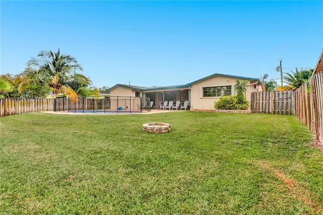 a view of a house with a yard and sitting area