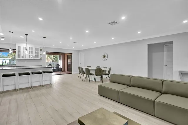 a living room with furniture and kitchen view