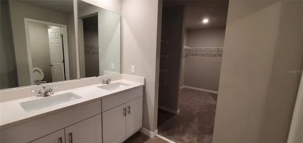 a bathroom with a sink and mirror