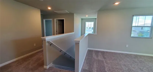 a view of a hallway with windows