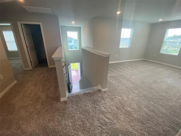 an empty room with windows and entrance