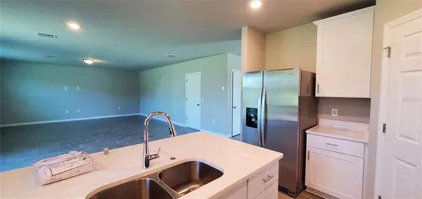 a kitchen with a sink and refrigerator