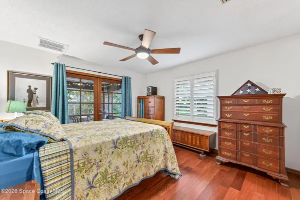 a bedroom with a bed and a large window