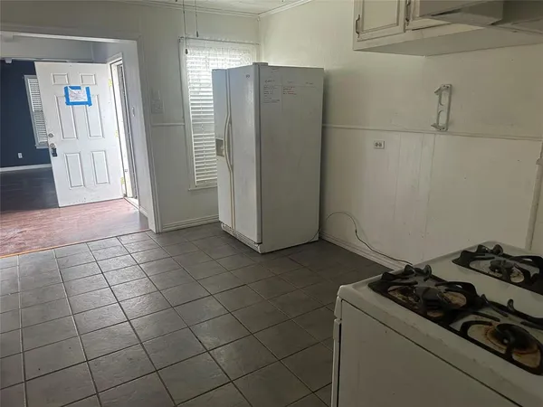 a kitchen with a stove and a refrigerator