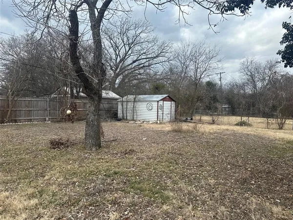 a view of house covered with snow in yard