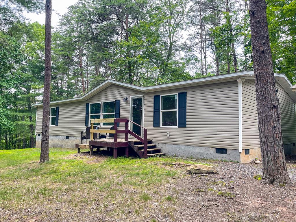a front view of house with yard outdoor seating and barbeque oven