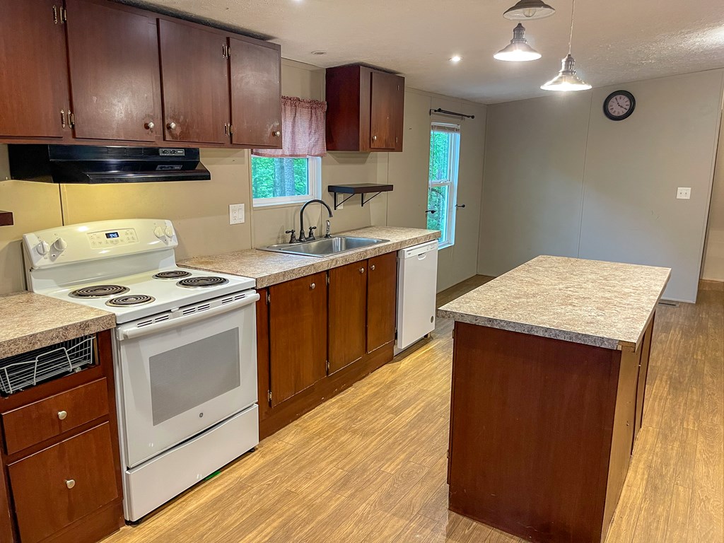 89 Kanati Trail Murphy, NC 28906 - Photo 12 of 30 a kitchen with stainless steel appliances granite countertop wooden cabinets sink and stove