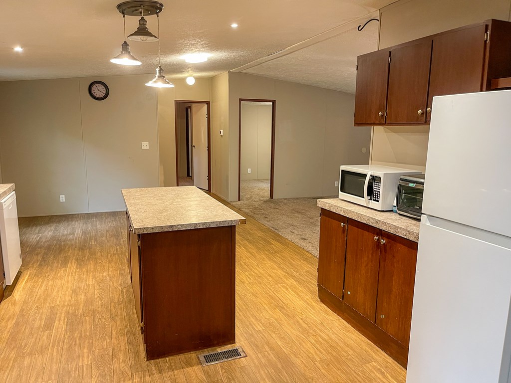 89 Kanati Trail Murphy, NC 28906 - Photo 13 of 30 a kitchen with kitchen island a counter top space a sink a refrigerator and wooden floor