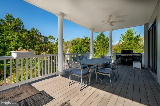 a living room with furniture wooden floor and a large window
