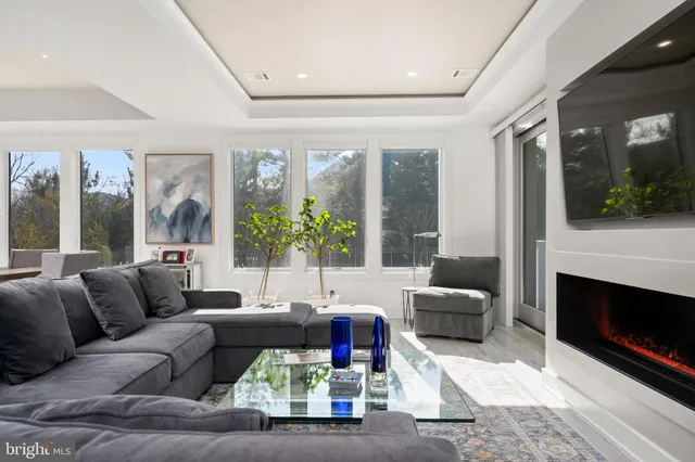 a white kitchen with stainless steel appliances granite countertop a stove and a refrigerator