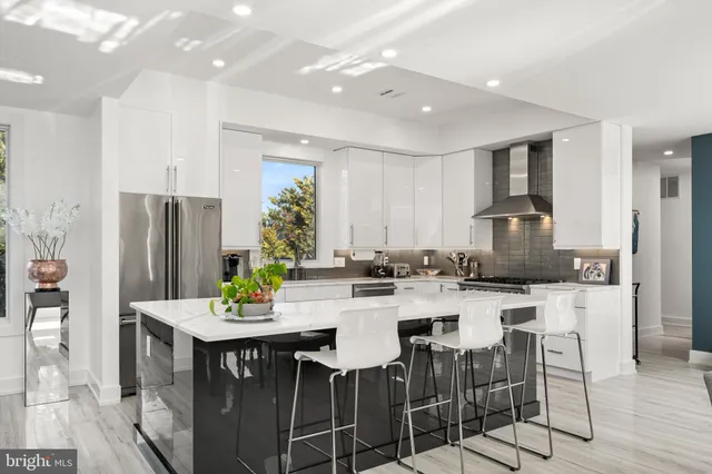 a large kitchen with a large counter space and stainless steel appliances
