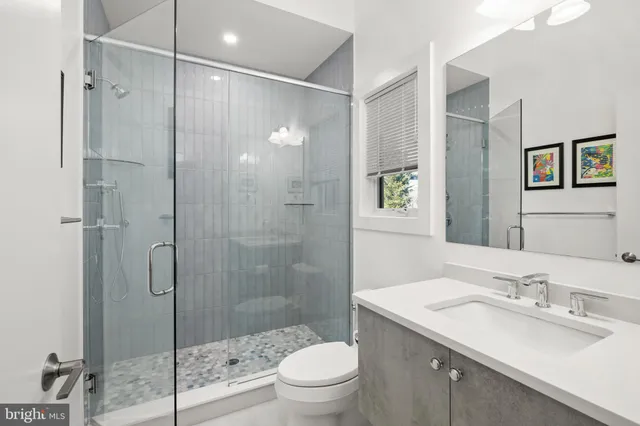 a spacious bedroom with a bed a couch and a window