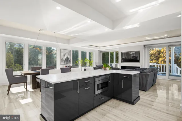 a living room with furniture large window and flat screen tv