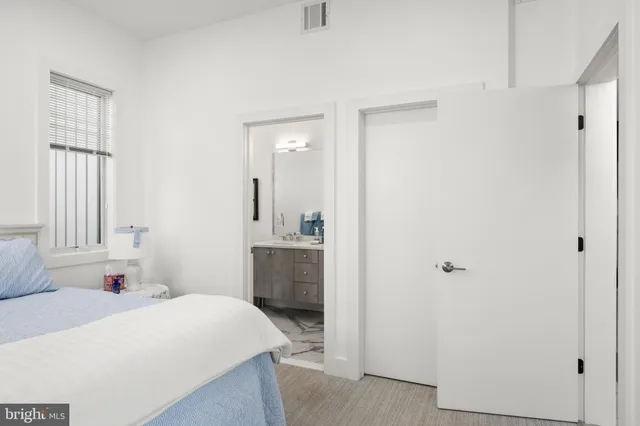 a bedroom with a bed and a large window