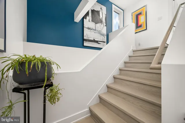 a bathroom with a granite countertop sink mirror vanity and toilet