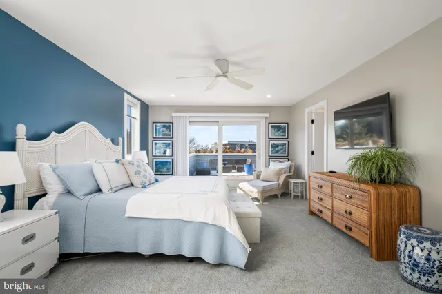 a bedroom with a large bed and a large window